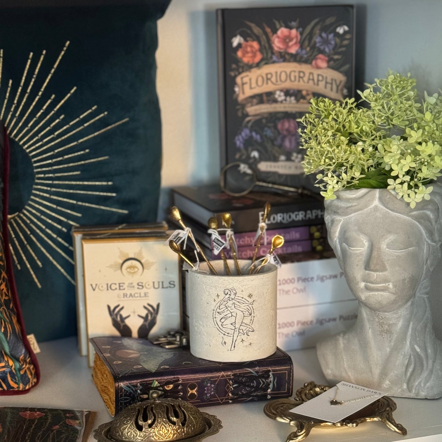 Decorative items including a candle, books, and a vase on a shelf.