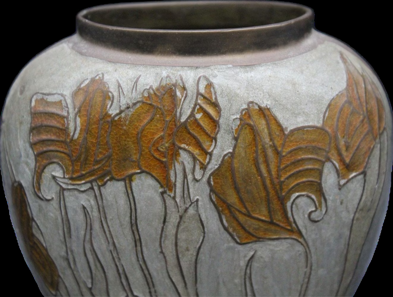Close up view of enameled irises on brass vase.