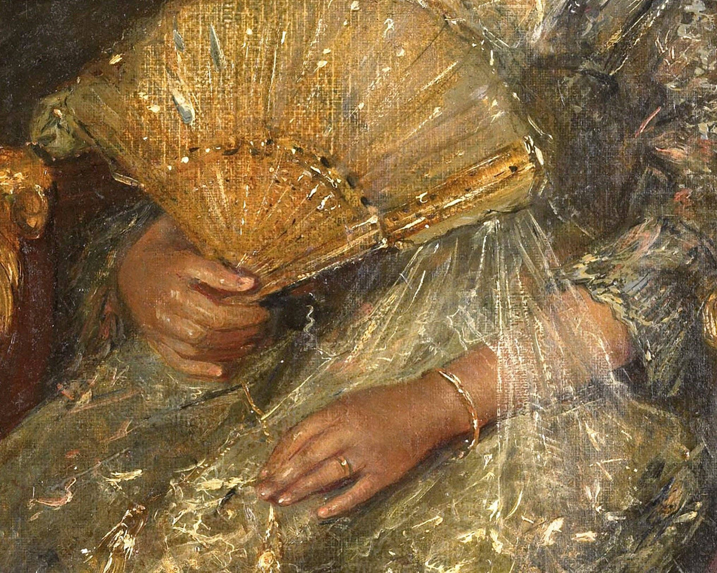 Close-up of a person holding a decorative fan with intricate details.