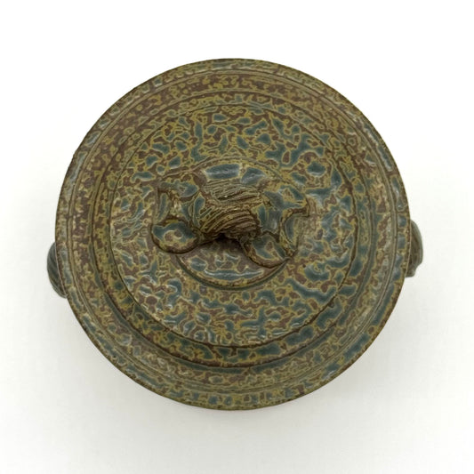 Decorative pottery with intricate patterns on a white background