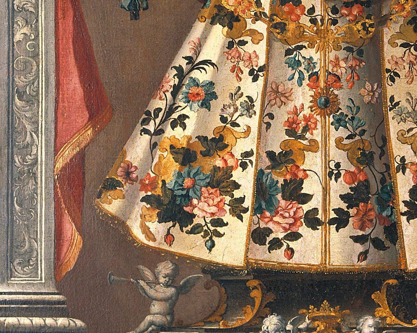 Decorative fabric with floral patterns and an angel figure at the bottom.