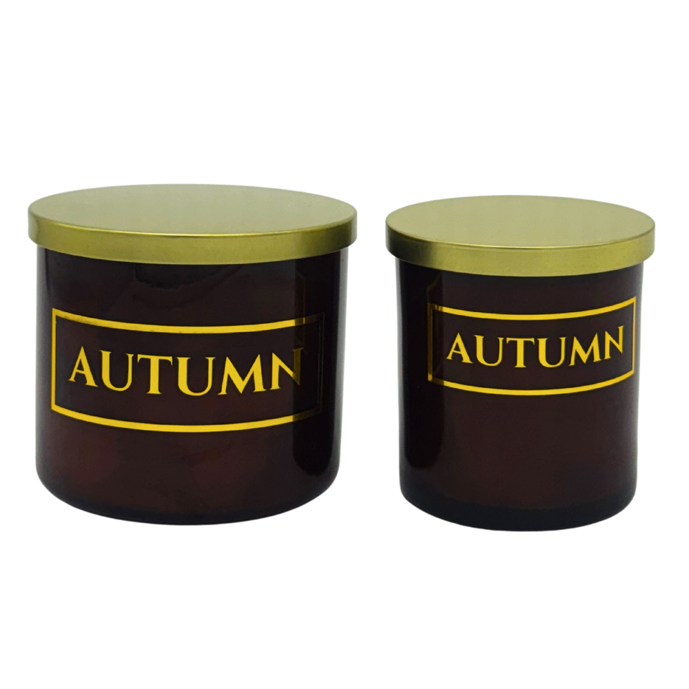 Two amber jars with gold lids and 'AUTUMN' label on a white background