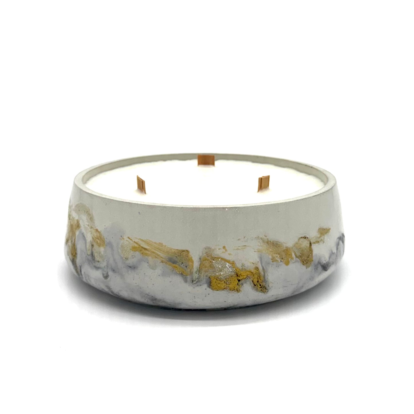 Concrete candle with black and gold accents on a white background