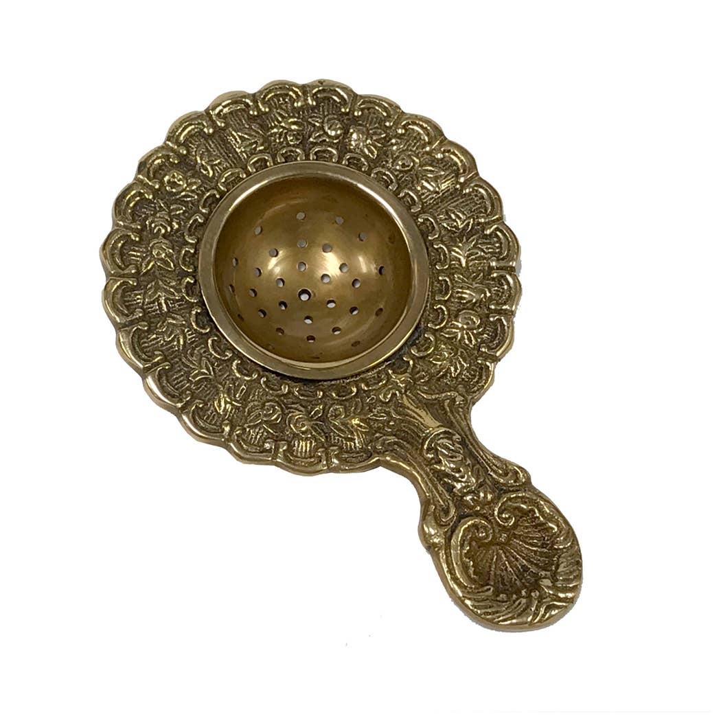 Brass Decorative Tea Strainer on white background.