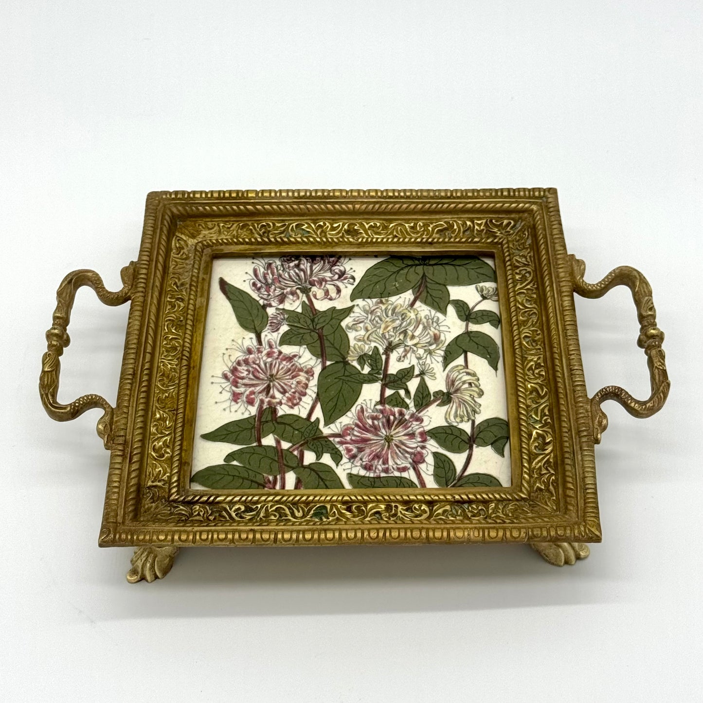 Decorative tray with floral design on a white background