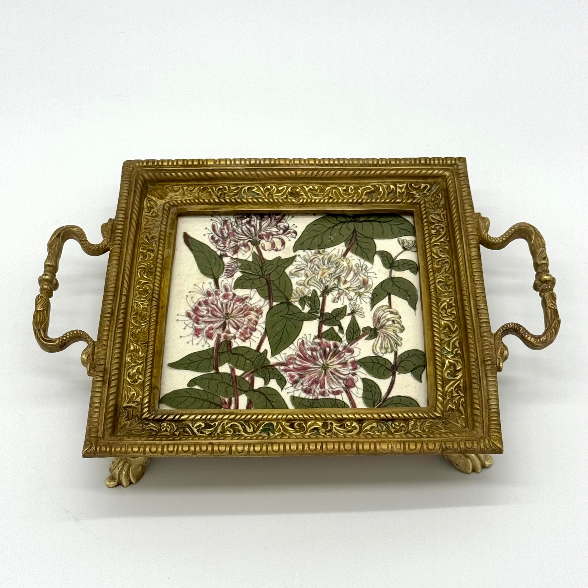 Decorative tray with floral design on a white background