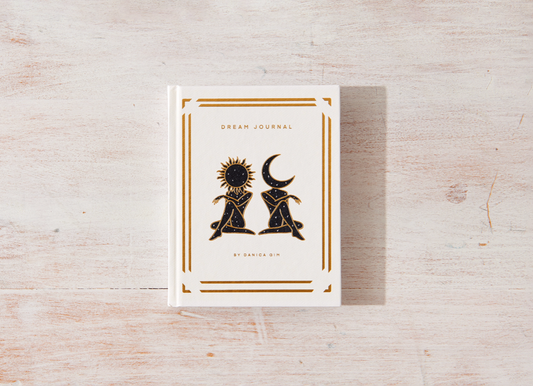 Dream journal with celestial design on a wooden surface