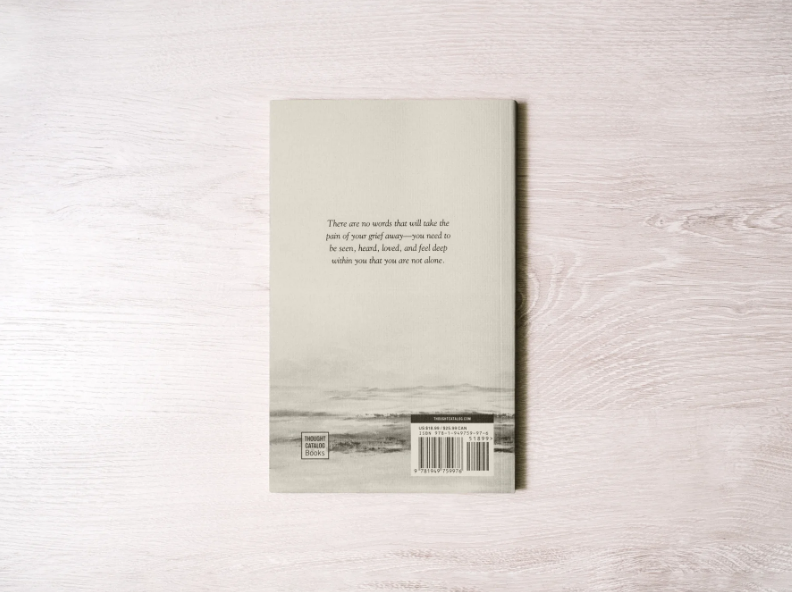 Book cover with text on a light wooden surface