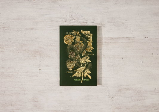 Book with floral design and text on a light wooden surface