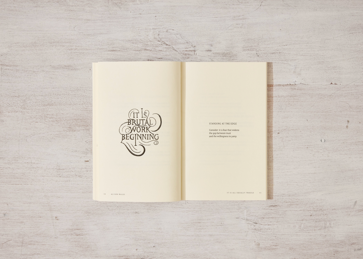 Open book with text on a wooden surface