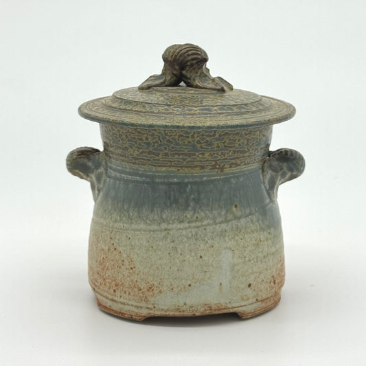 Stoneware jar with lid on a white background