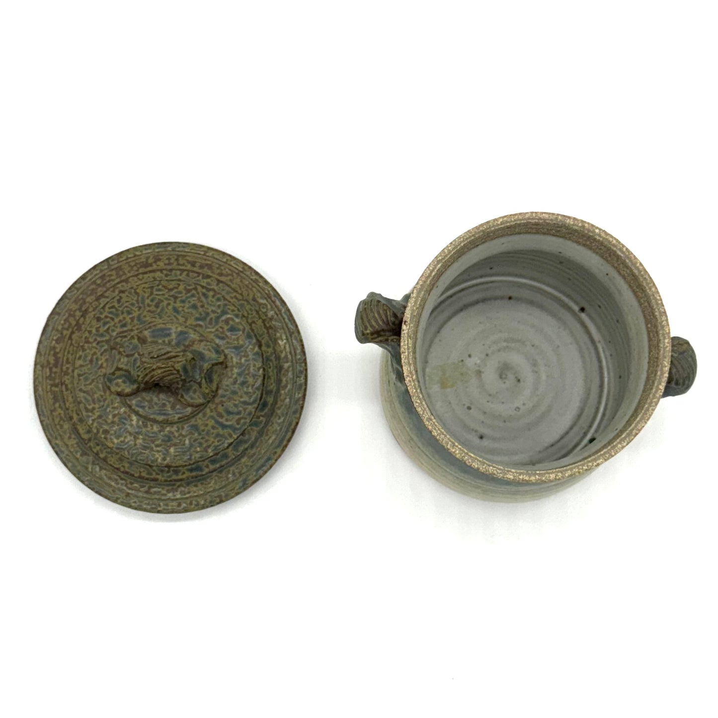 Ceramic jar with decorative lid on a white background