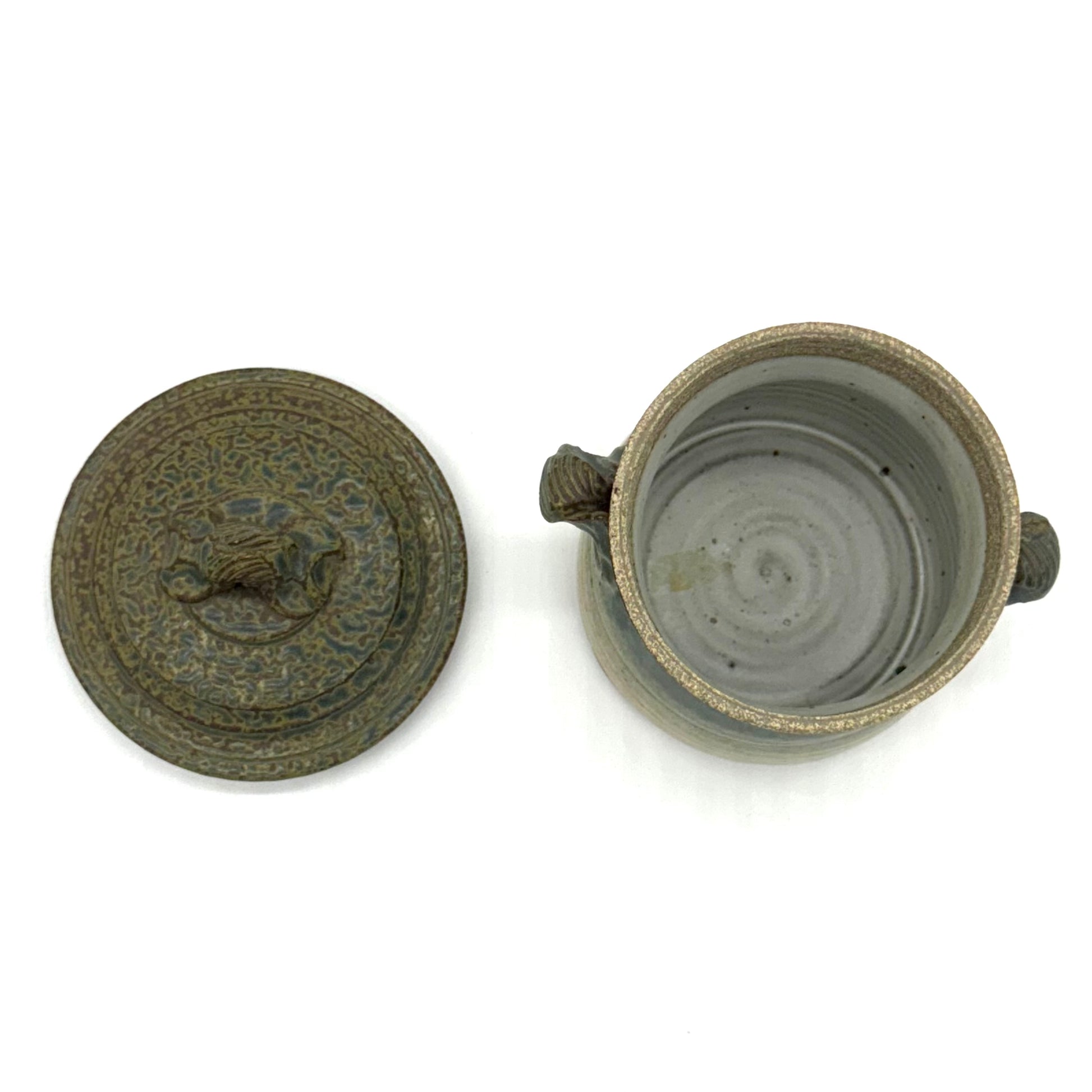 Ceramic jar with decorative lid on a white background