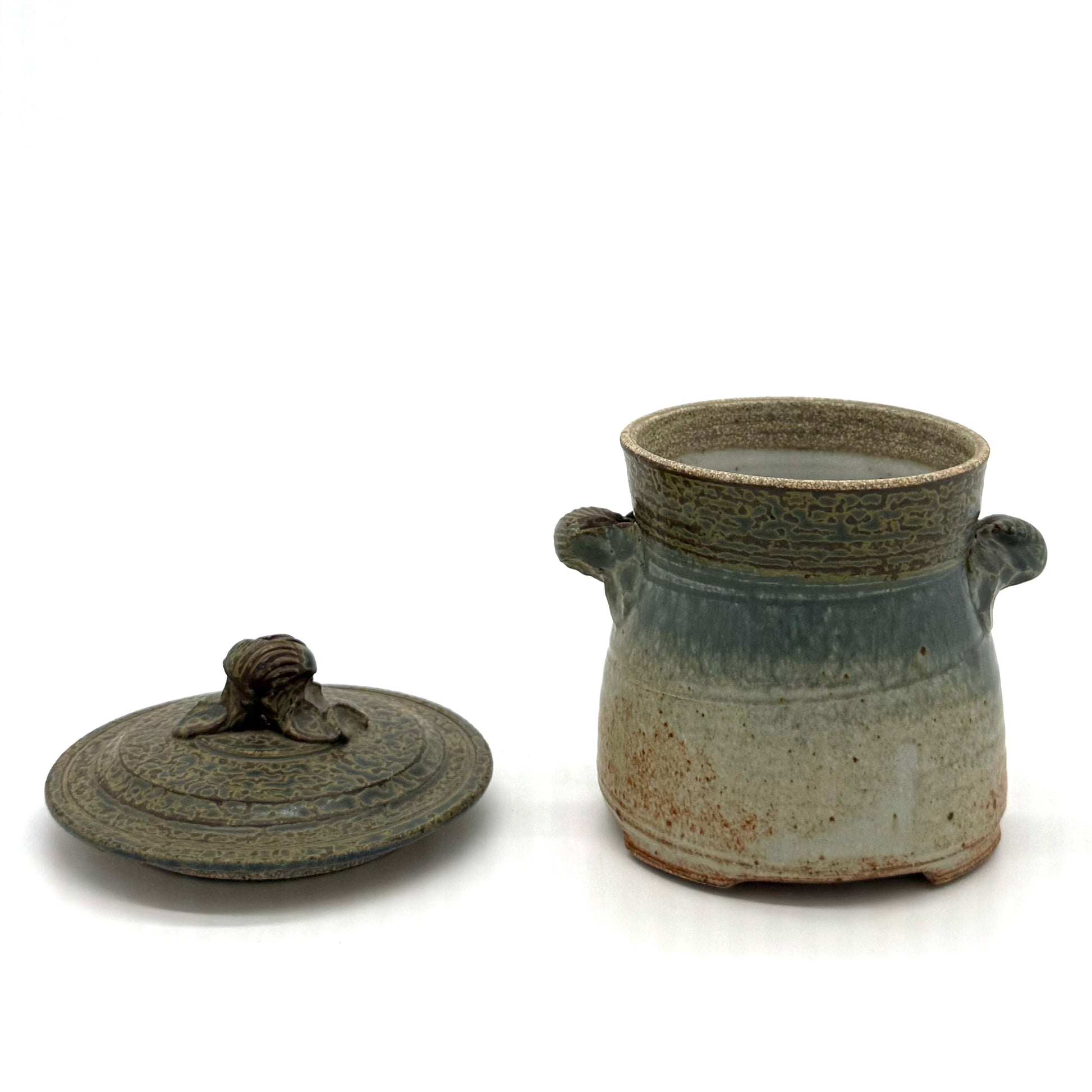 Stoneware jar with lid on a white background