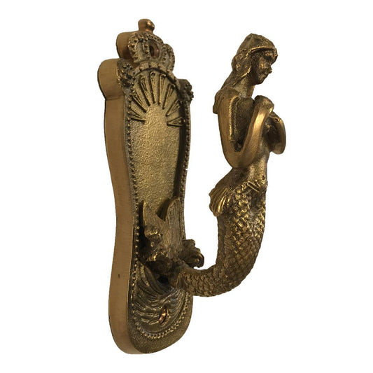 Vintage decorative mermaid door knocker on white background.
