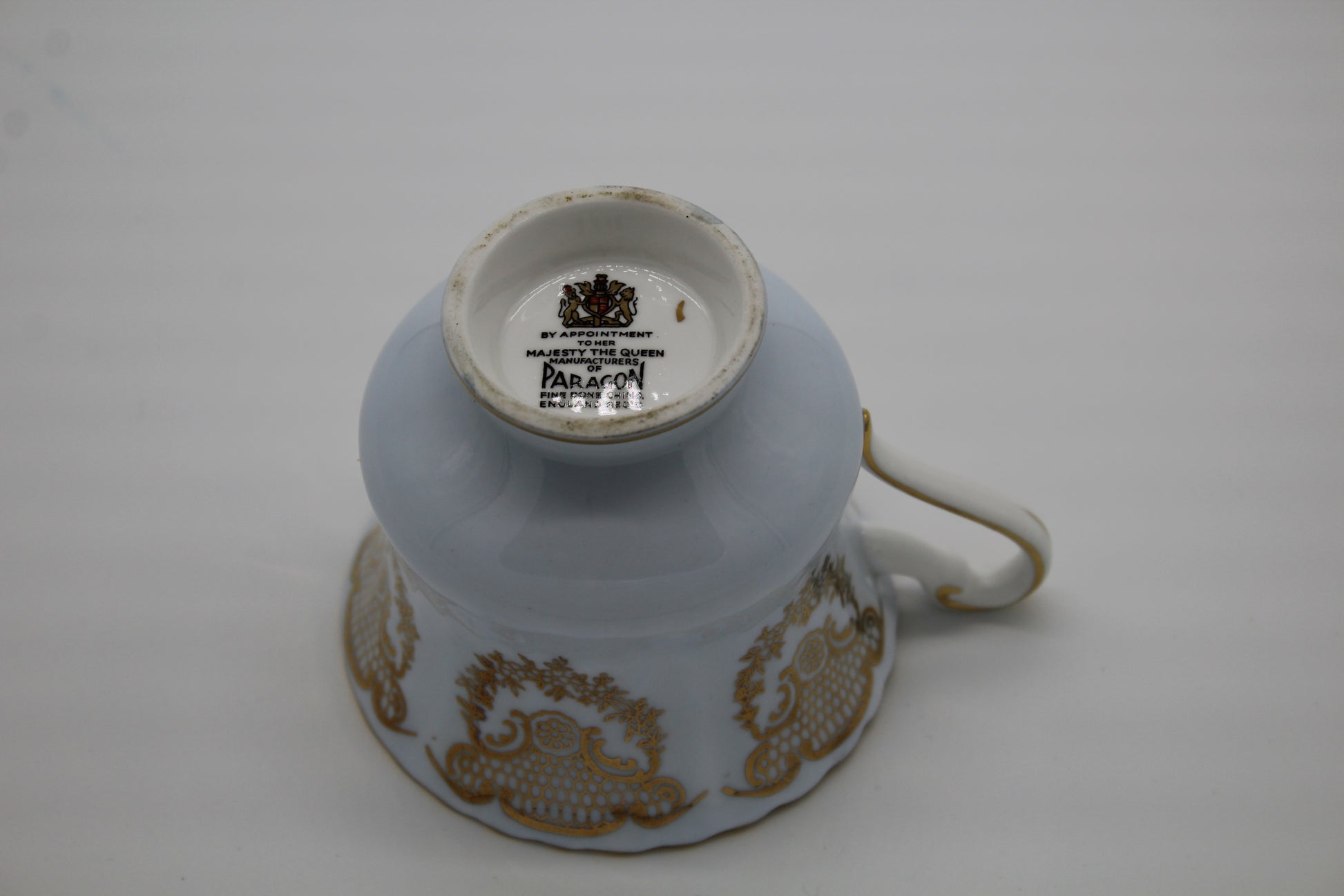 Ceramic cup with gold patterns on a white background