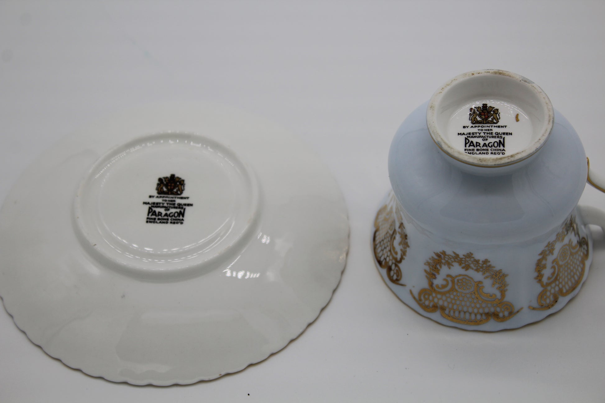 Paragon cup and saucer with gold patterns on a white background