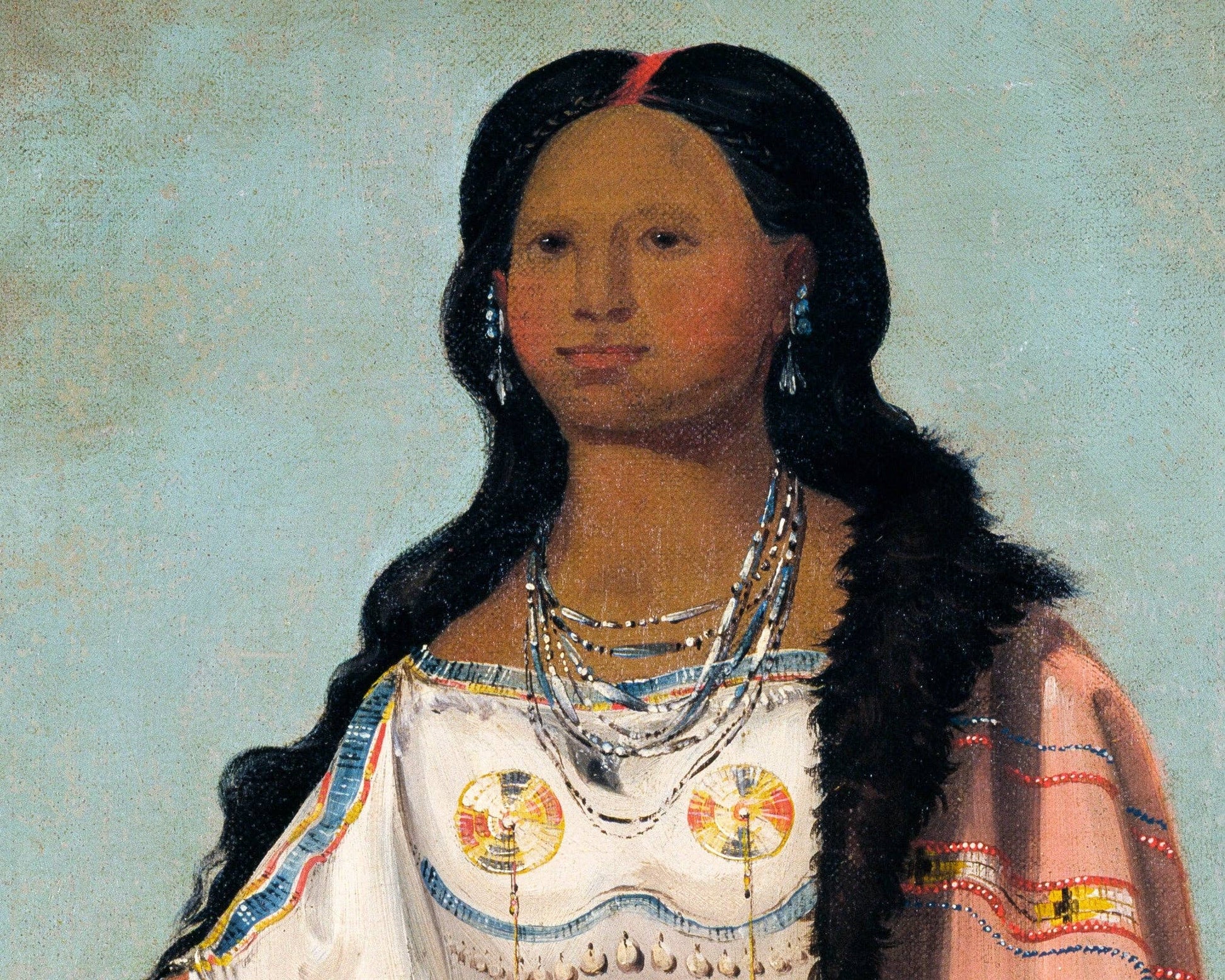 Portrait of a Native American woman with long hair and traditional clothing against a light blue background