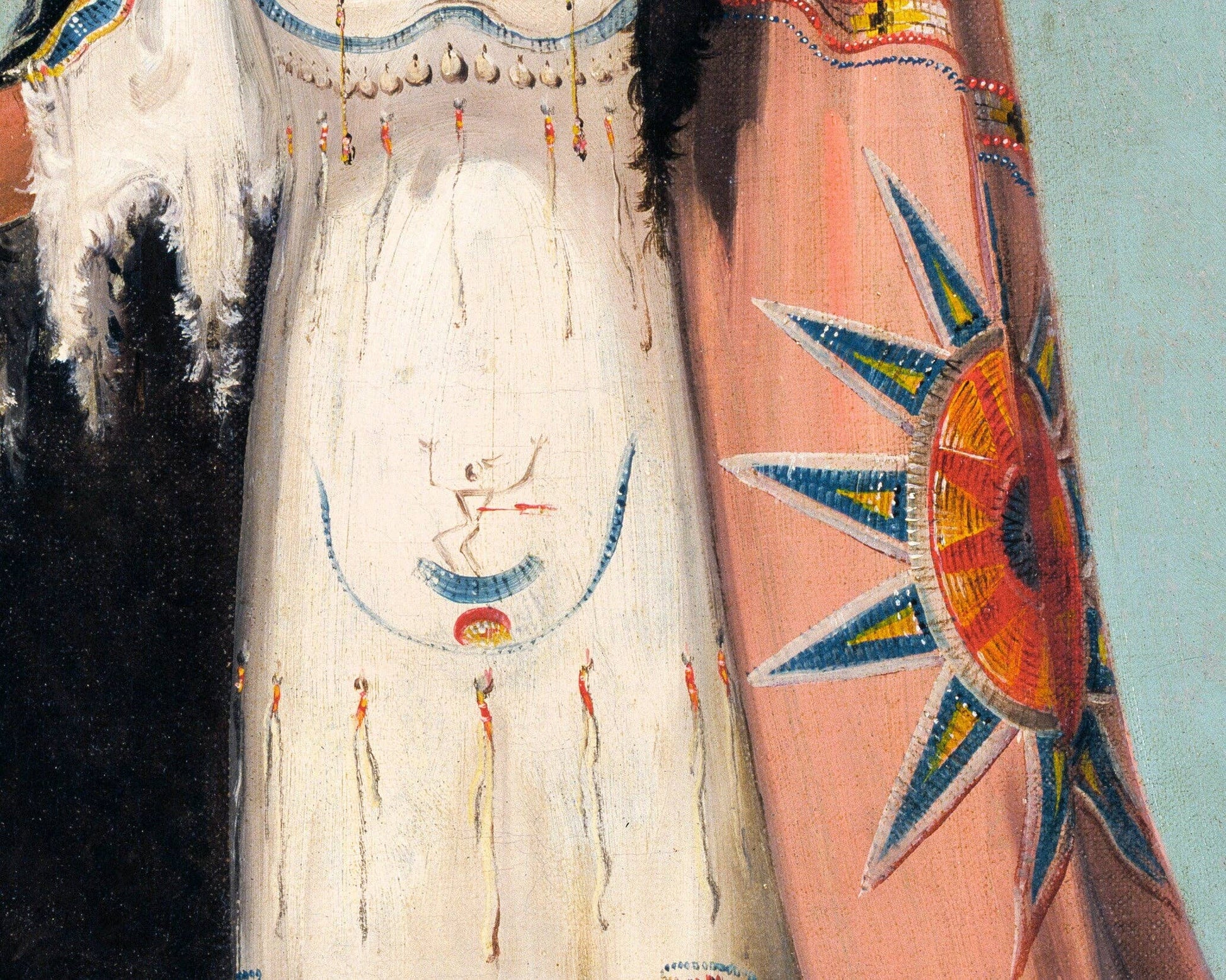 Close-up of a Native American garment with intricate beadwork and patterns.