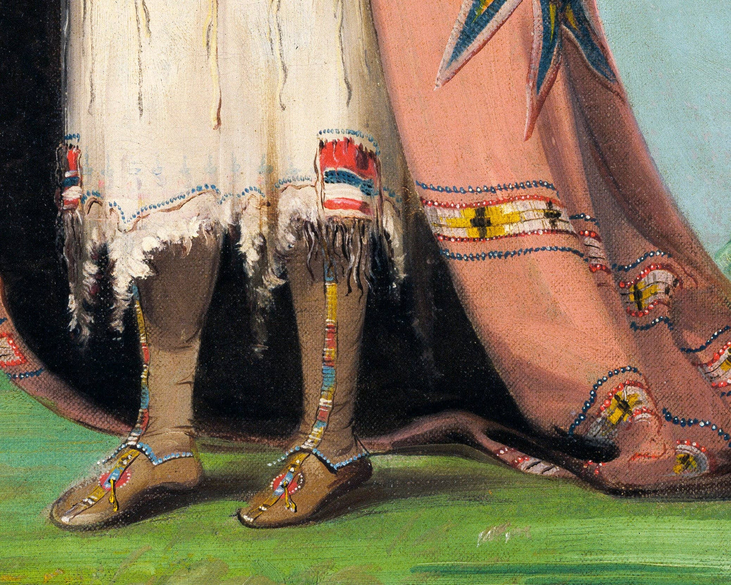 Traditional Native American clothing with beaded moccasins on a grassy background