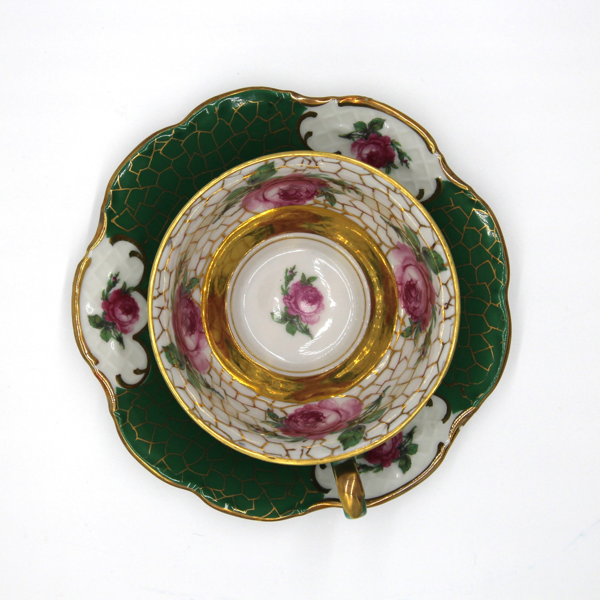 Decorative teacup and saucer with floral patterns on a white background