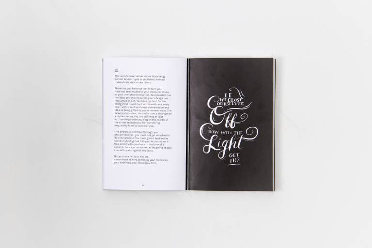 Open book with black and white design on a light gray background