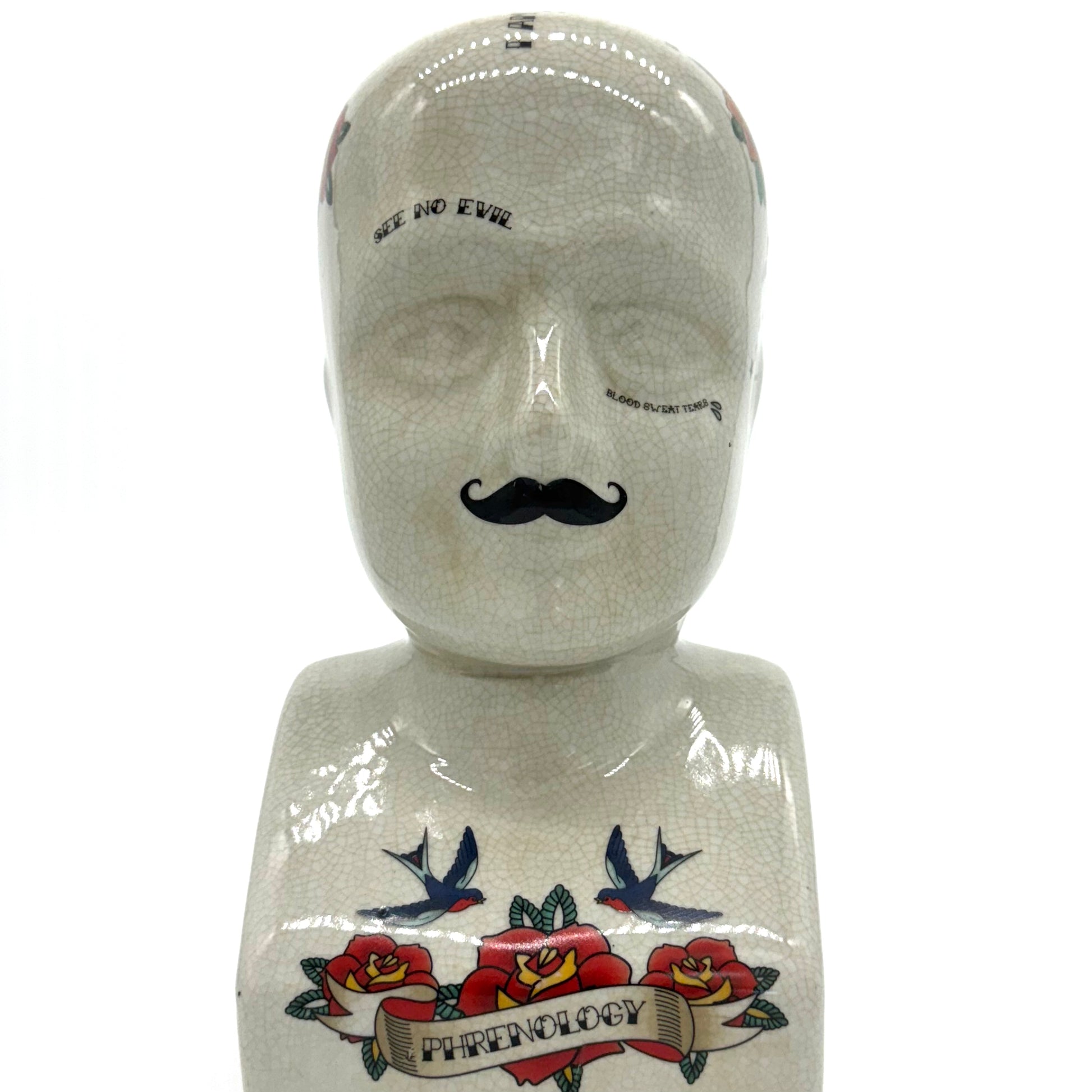 Mannequin head with tattoos and mustache on a white background