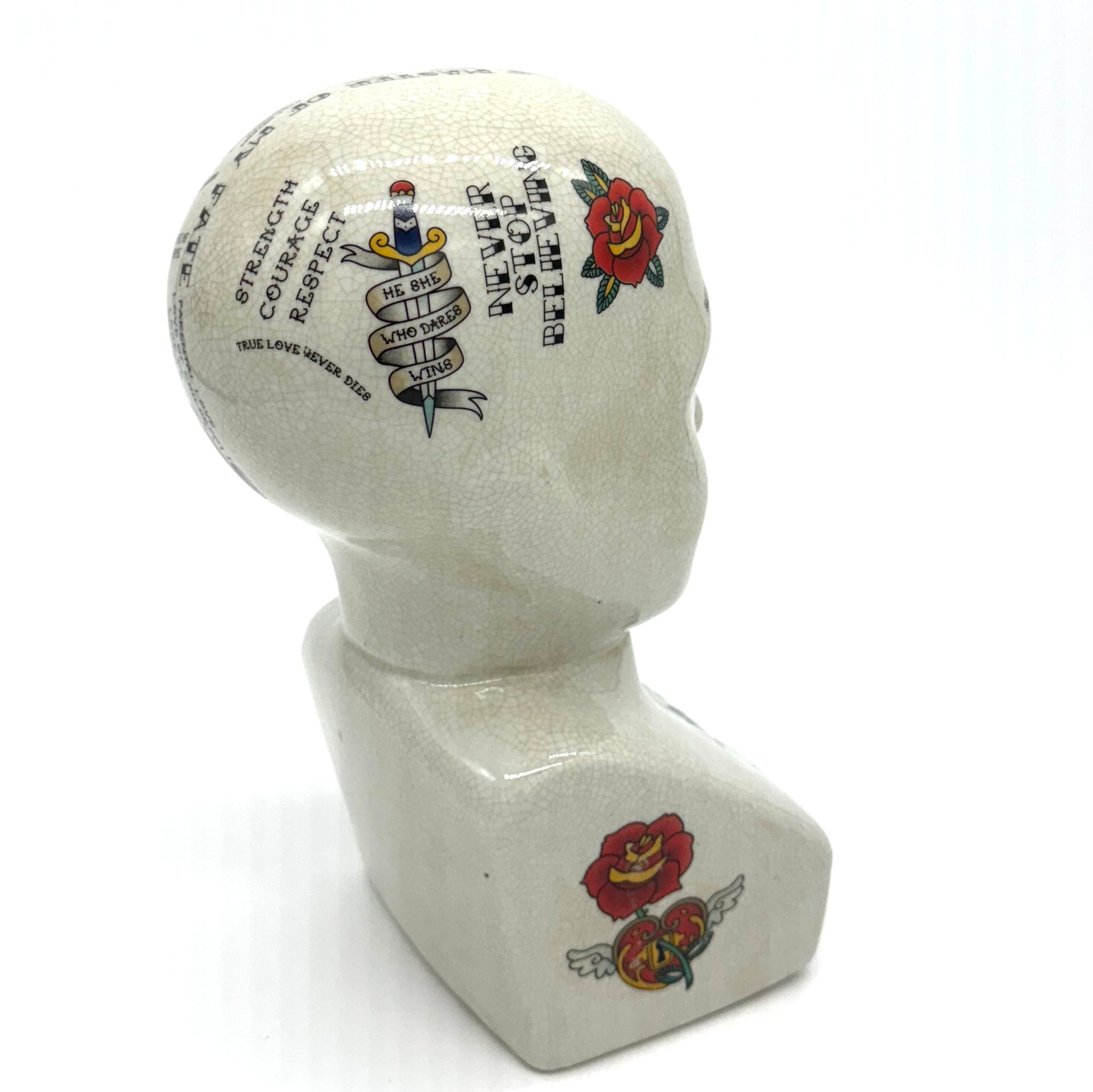 Decorative head with tattoo-like designs on a white background